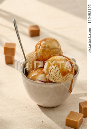 Caramel gelato ice cream with caramel sauce in bowl Caramel gelato ice cream with caramel sauce in bowl 139498195