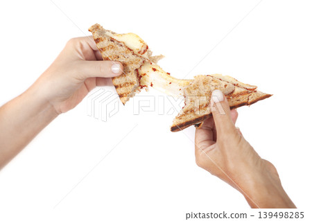 Tomato Sauce And Cheese Toast Sandwich Being Split on White. Tomato Sauce And Cheese Toast Sandwich Being Split on White. 139498285