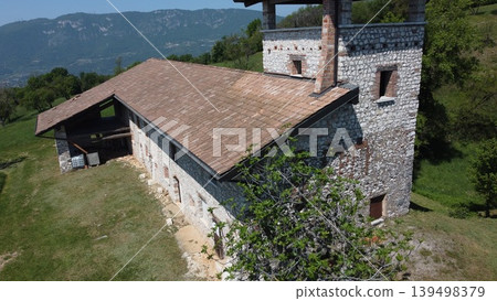 Aerial view of a traditional stone farmhouse with tower in the Italian countryside. 139498379