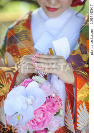 一位身著傳統日式服飾的新娘,手捧結婚戒指和球形花束,身穿色彩艷麗的打褂和服,在日式庭園中舉行神道教婚禮儀式 | 日本婚禮新娘廣告及圖片素材 一位身著傳統日式服飾的新娘,手捧結婚戒指和球形花束,身穿色彩艷麗的打褂和服,在日式庭園中舉行神道教婚禮儀式 | 日本婚禮新娘廣告及圖片素材 139498567