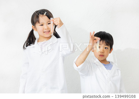 Child holding a test tube 139499108