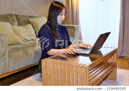 A peaceful moment for oneself. The daily life of a woman enjoying the internet and hobbies in a relaxed space. A peaceful moment for oneself. The daily life of a woman enjoying the internet and hobbies in a relaxed space. 139499145