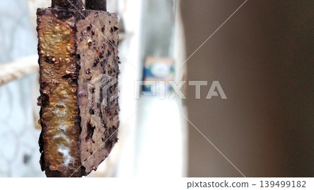 Close-up image of a rusty padlock with a corroded metal texture. Close-up image of a rusty padlock with a corroded metal texture. 139499182