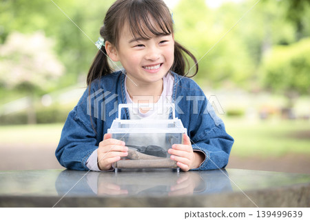 Catching insects like rhinoceros beetles and other bugs is a fun and exciting activity for girls, perfect for summer vacation experiences and independent research projects. 139499639