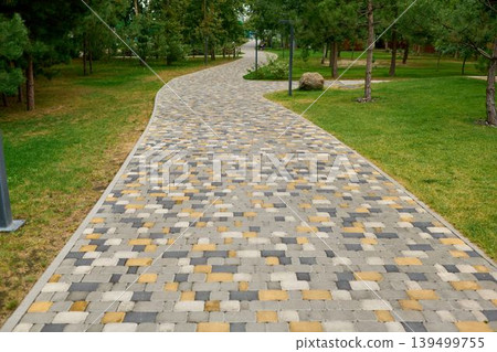 Winding paved path through the park. 139499755