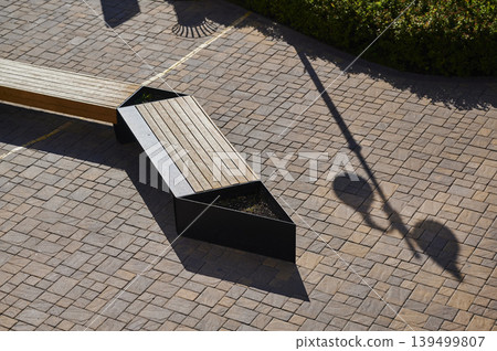 Creative outdoor seating blends modern design with nature in a lively urban space Creative outdoor seating blends modern design with nature in a lively urban space 139499807