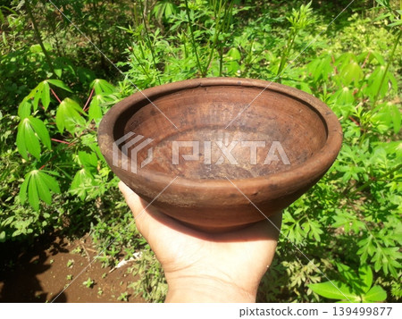 Holding Authentic Ancient Clay Plate Under Bright Sunlight 139499877