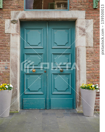 Beautiful teal door with stylish planters 139500013
