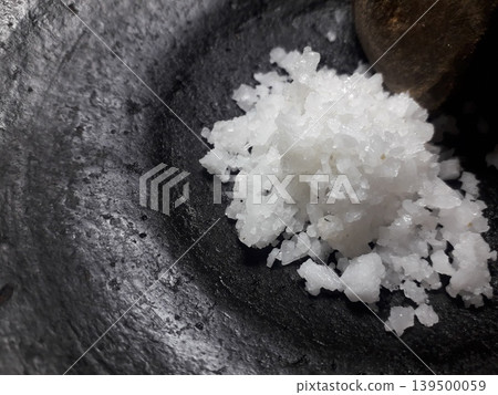 White Salt Crystals on Black Clay Mortar with Copy Space on Left White Salt Crystals on Black Clay Mortar with Copy Space on Left 139500059