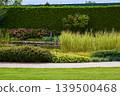 Serenity unfolds in a vibrant garden with lush greenery and blooming flowers 139500468