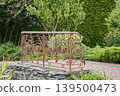 Beautiful decorative railing surrounded by lush greenery and elegant garden design 139500473