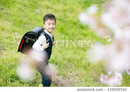 Elementary school boy carrying a school bag Elementary school boy carrying a school bag 139500582