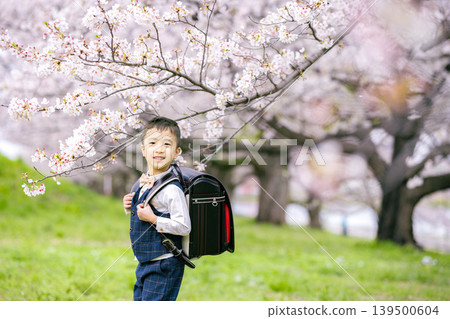 A boy carrying a school bag A boy carrying a school bag 139500604