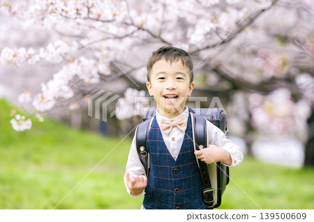 A boy carrying a school bag A boy carrying a school bag 139500609