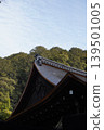 The beautiful roofs of historic shrines and temples stand against a backdrop of lush green mountains. 139501005