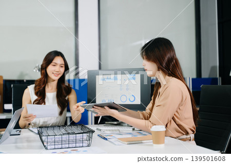 Business colleagues having casual conversation during coffee break in modern office, showing teamwork, communication, and relaxed Business colleagues having casual conversation during coffee break in modern office, showing teamwork, communication, and relaxed 139501608