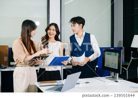 Group of Young Asian business team creative businesspeople coworker, teamwork celebrating achievement and in planning design in office Group of Young Asian business team creative businesspeople coworker, teamwork celebrating achievement and in planning design in office 139501644