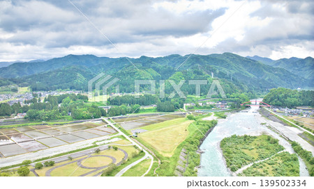 A cloudy May day, showing the Kurobe River alluvial fan and surrounding facilities such as Aimoto Bridge and parks, where it looks like it might rain. A cloudy May day, showing the Kurobe River alluvial fan and surrounding facilities such as Aimoto Bridge and parks, where it looks like it might rain. 139502334
