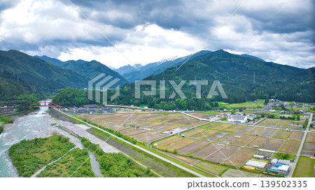 A cloudy May day, showing the Kurobe River alluvial fan and surrounding facilities such as Aimoto Bridge and parks, where it looks like it might rain. A cloudy May day, showing the Kurobe River alluvial fan and surrounding facilities such as Aimoto Bridge and parks, where it looks like it might rain. 139502335