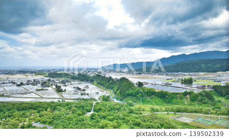 A cloudy May day, showing the Kurobe River alluvial fan and surrounding facilities such as Aimoto Bridge and parks, where it looks like it might rain. A cloudy May day, showing the Kurobe River alluvial fan and surrounding facilities such as Aimoto Bridge and parks, where it looks like it might rain. 139502339
