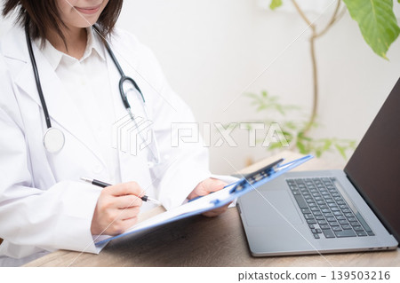 A female doctor checking the medical questionnaire. 139503216
