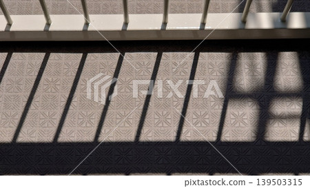 The shadows of a geometric grid projected onto the floor. The shadows of a geometric grid projected onto the floor. 139503315
