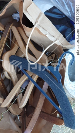 Wooden hangers and everyday items piled up haphazardly. Wooden hangers and everyday items piled up haphazardly. 139503693