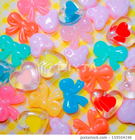 A Y2K-style background featuring a collection of pop, colorful beads and fancy parts. A Y2K-style background featuring a collection of pop, colorful beads and fancy parts. 139504196