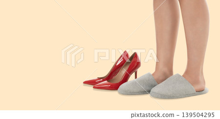 A woman displays high heels and slippers A woman displays high heels and slippers 139504295