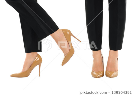 Woman shows two styles of heels with black pants, isolated, PNG Woman shows two styles of heels with black pants, isolated, PNG 139504391