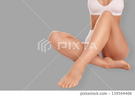 Individual performing self-care while sitting comfortably indoors Individual performing self-care while sitting comfortably indoors 139504406