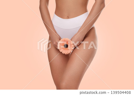A person holds a flower while showcasing body care practices 139504408