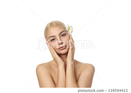 Woman uses gentle skincare, flower in hair, isolated on white, PNG Woman uses gentle skincare, flower in hair, isolated on white, PNG 139504421