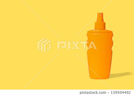 Orange mustard bottle sits against a sunny yellow backdrop 139504492