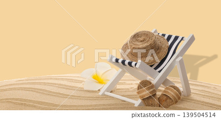 Beach chair with striped fabric and straw hat resting on sand Beach chair with striped fabric and straw hat resting on sand 139504514