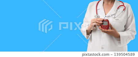 Health expert demonstrates a digital monitor in a clinical setting 139504589