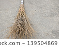 Bamboo broom and concrete background 139504869