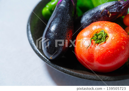 Assortment of fresh, dewy summer vegetables: tomatoes, eggplant, cucumbers, zucchini, and peppers Assortment of fresh, dewy summer vegetables: tomatoes, eggplant, cucumbers, zucchini, and peppers 139505723