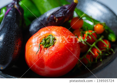 Assortment of fresh, dewy summer vegetables: tomatoes, eggplant, cucumbers, zucchini, and peppers Assortment of fresh, dewy summer vegetables: tomatoes, eggplant, cucumbers, zucchini, and peppers 139505724