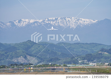 Sendai Airport on a sunny day: Zao mountain range and a plane taking off. Natori City, Miyagi Prefecture. 139506079