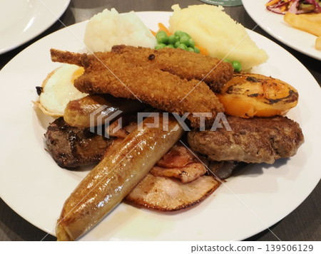 A beautifully presented mixed plate—a satisfying dish featuring a variety of meat dishes. A beautifully presented mixed plate—a satisfying dish featuring a variety of meat dishes. 139506129