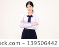 Confident Asian high school student girl in Thai school uniform standing with arms crossed, smiling at camera, isolated on white background. 139506442