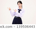 Excited Asian high school student girl in Thai school uniform pointing fingers at copy space for advertising, smiling happily, isolated on white background. 139506443