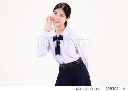 Happy Asian high school student girl in Thai school uniform shouting and announcing with hand around mouth, isolated on white background. Happy Asian high school student girl in Thai school uniform shouting and announcing with hand around mouth, isolated on white background. 139506444