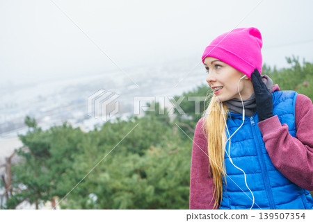 Woman wearing sportswear exercising outside during autumn Woman wearing sportswear exercising outside during autumn 139507354