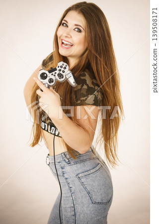 Gamer woman holding gaming pad Gamer woman holding gaming pad 139508171