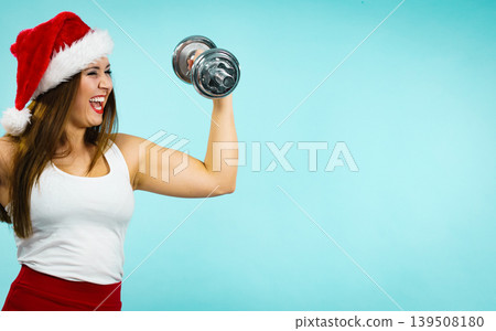 Santa claus woman lifting dumbbells Santa claus woman lifting dumbbells 139508180