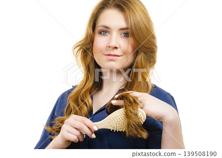 Woman brushing long healthy brown hair Woman brushing long healthy brown hair 139508190