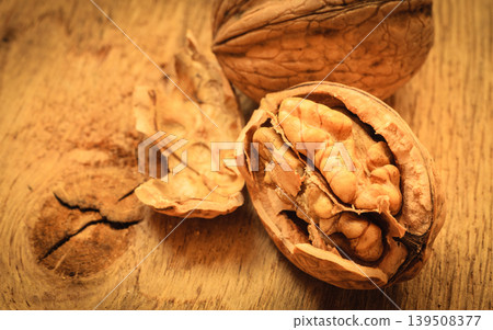 Whole walnuts on rustic old wooden table Whole walnuts on rustic old wooden table 139508377
