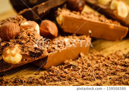 chocolate shavings and pieces on wooden table chocolate shavings and pieces on wooden table 139508380